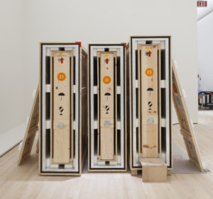 Wooden art crates lined up in a gallery