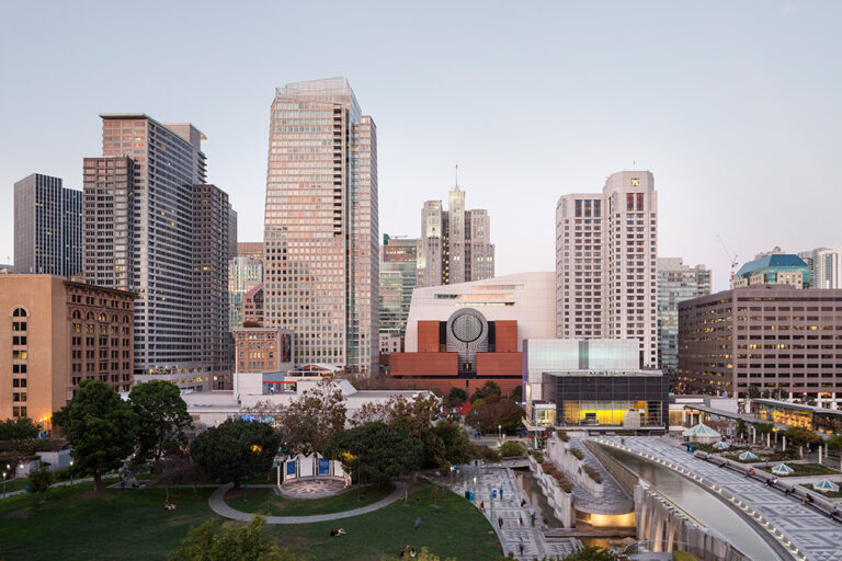 A panoramic color photograph of a manicured urban garden