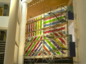 A colorful mural seen through scaffolding, Gatti