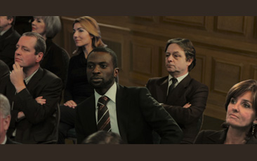 David Claerbout, video still of six people sitting in audience