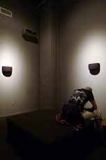 Anthony Discenza installation view of person in corner doing backbend