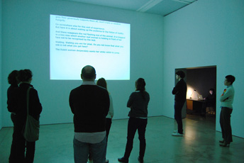 crowd of people looking at projection on wall