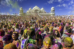 A sea of faces covered in multi-colored powder