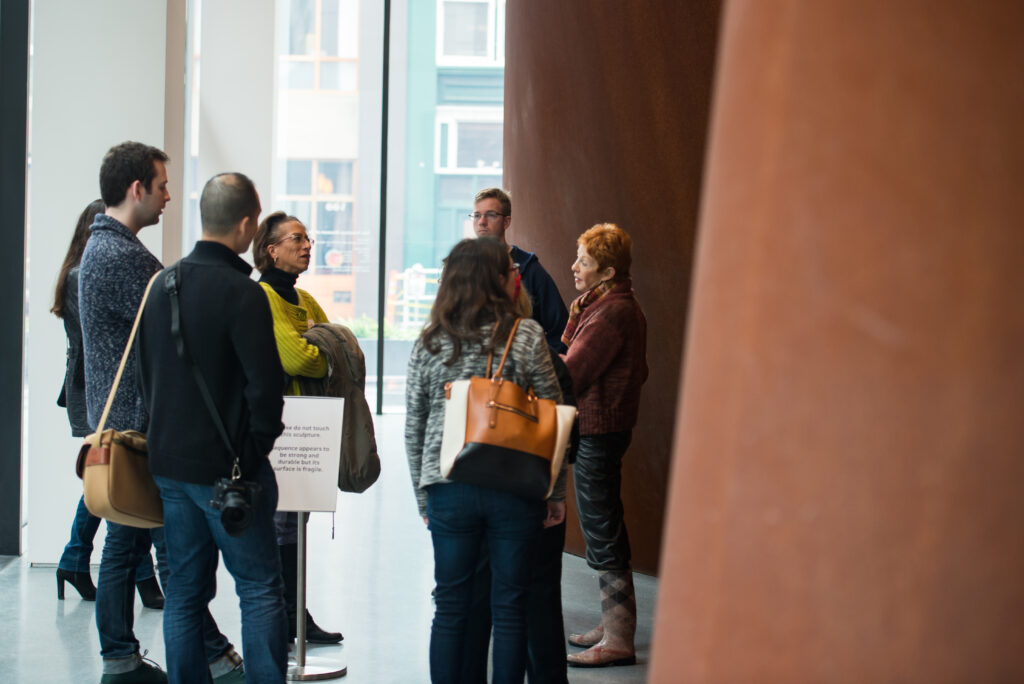 A tour standing outside of Richard Serra's Sequence