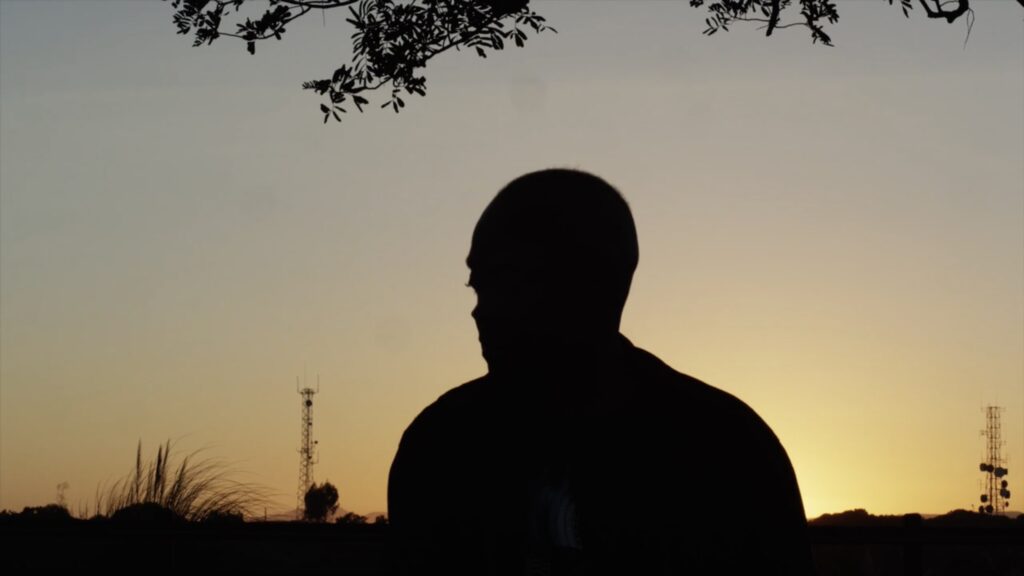 Silhouette of a man in front of a sunset