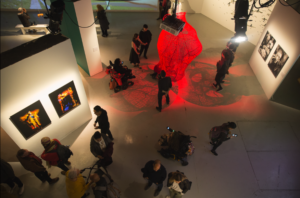 An overhead view of people browsing a contemporary art gallery.